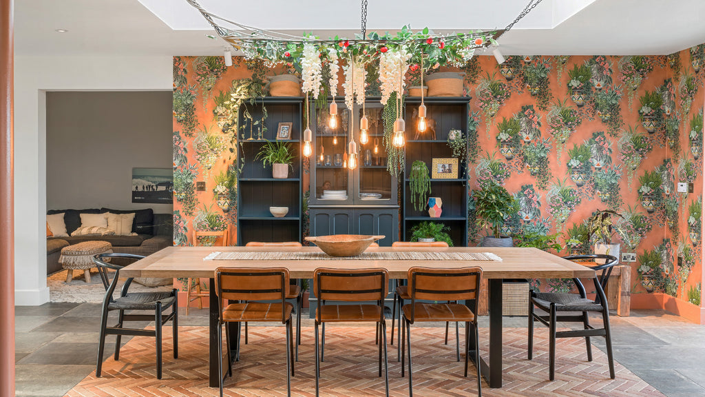 Mediterranean inspired dining room interior with roof light, bespoke hanging light fitting and, terracotta coloured wallpaper and floor tiles.